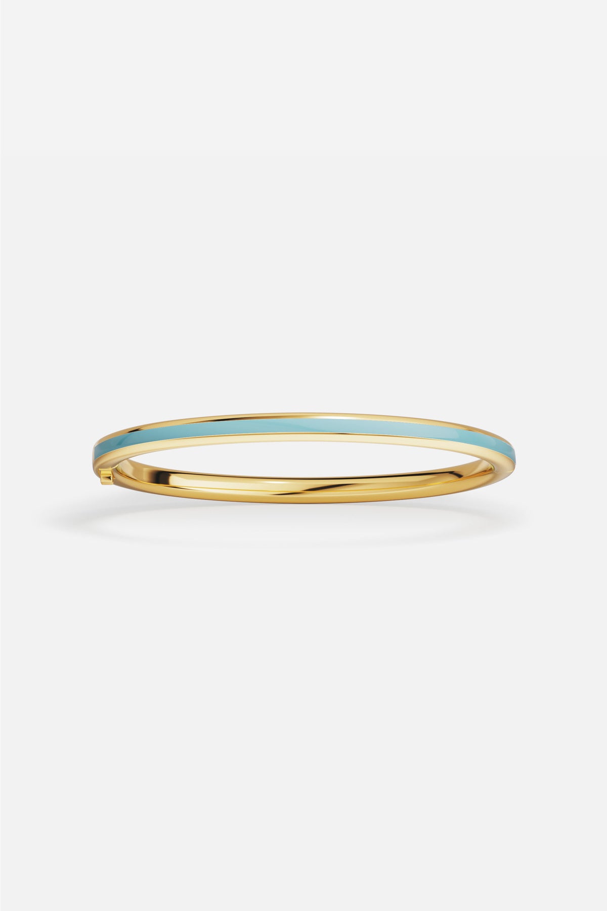 APM Bangle in gold tone with turquoise enamel, a breezy touch of Riviera charm.