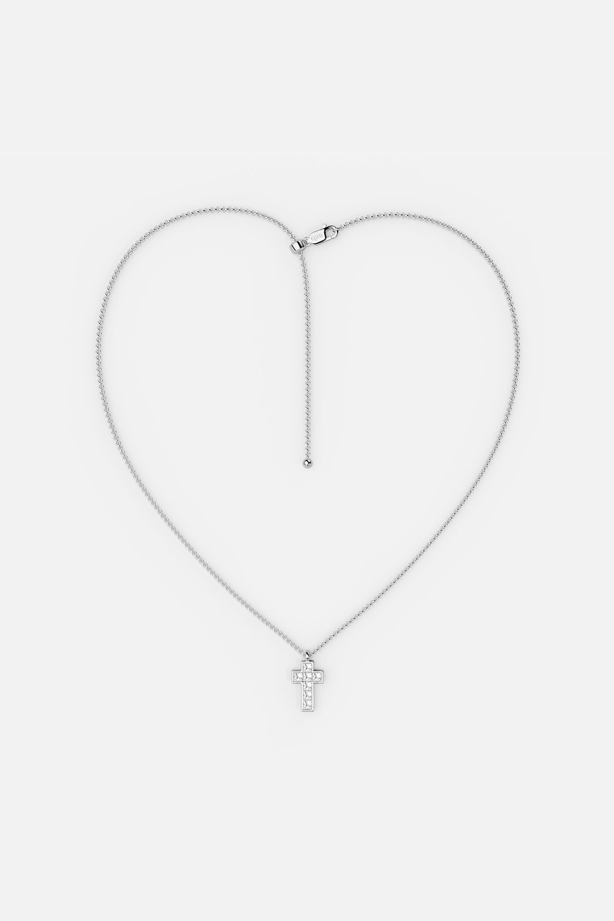 APM Cross Necklace in rhodium finish, a delicate emblem of quiet elegance.