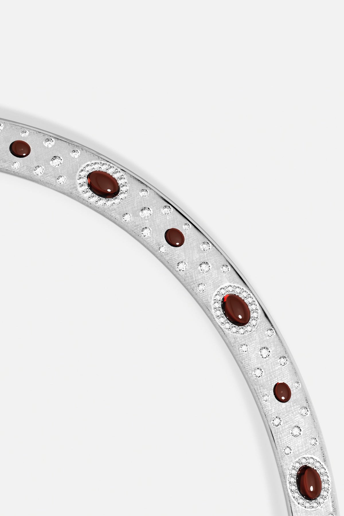 APM Bangle in rhodium finish, scattered crystals and deep red cabochons, quietly radiant.