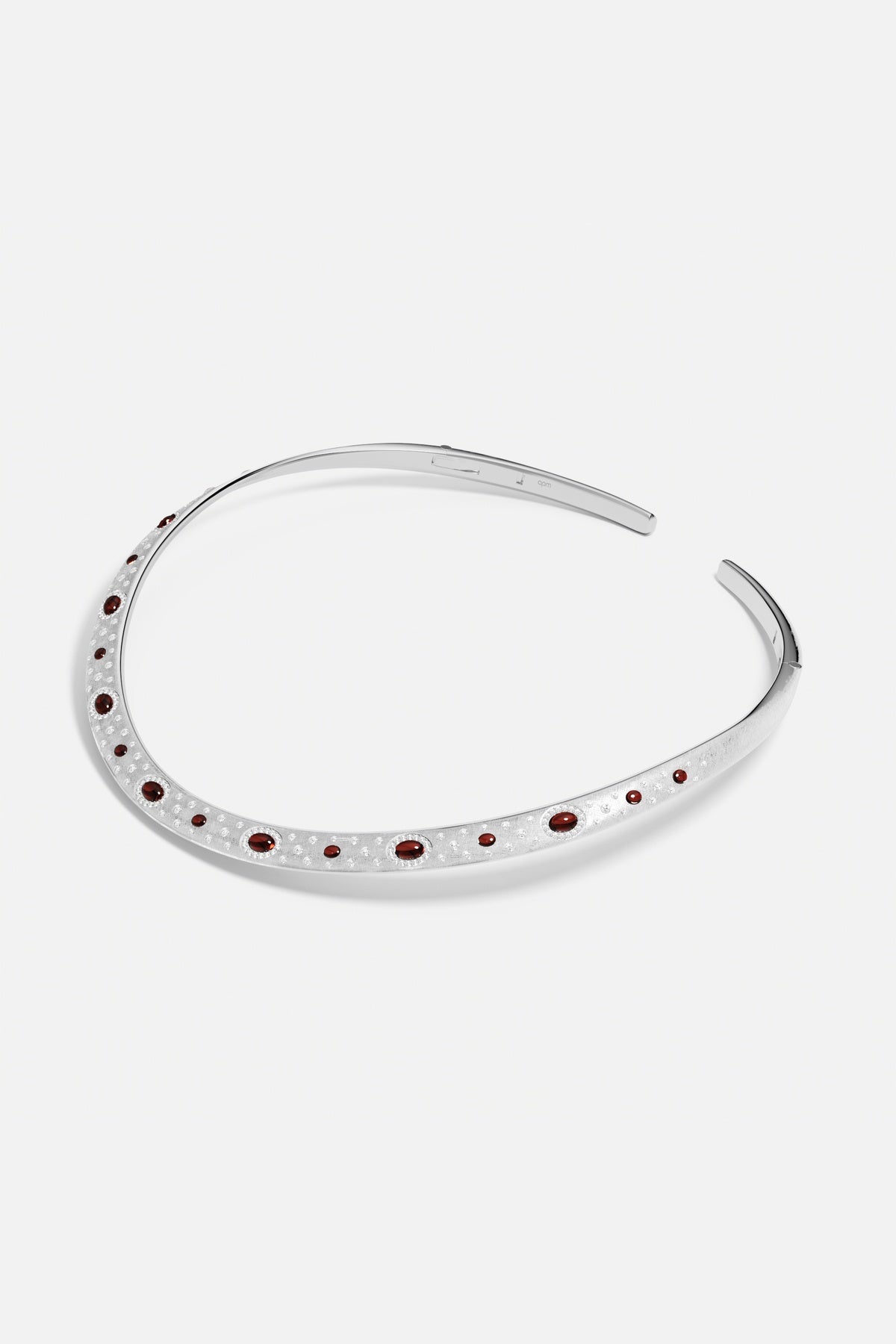 APM headband in rhodium finish, dotted with deep red accents, quietly regal.
