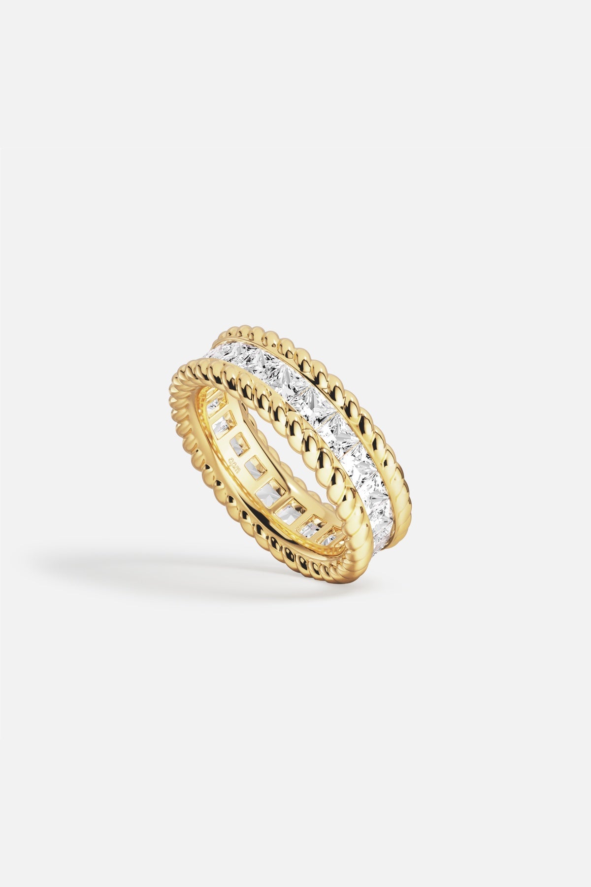 APM Ring in golden color, twisted edges framing brilliance, quiet everyday luxury.
