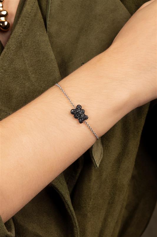 APM MONACO black Baby Mood Yummy Bear Adjustable Bracelet worn on hand with green background