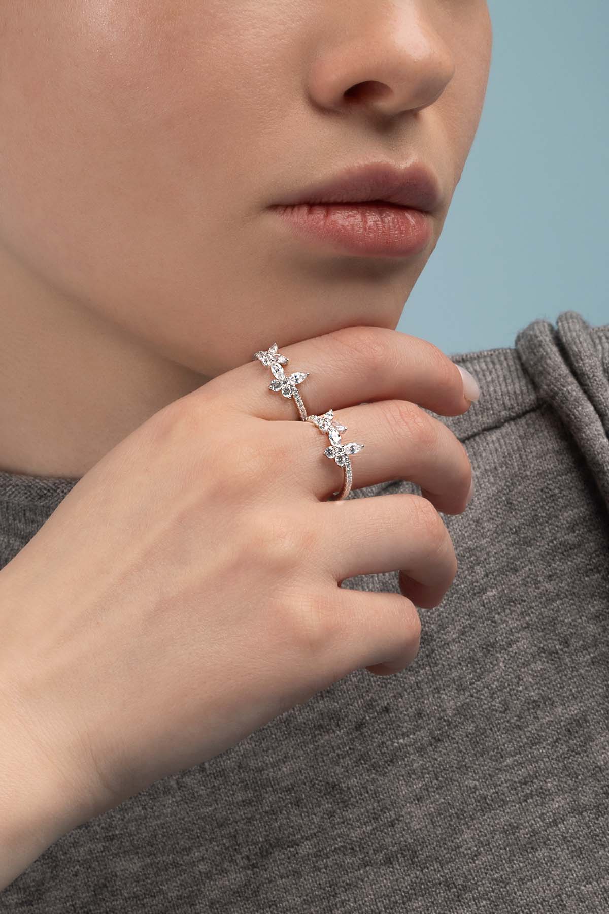 Rings APM Monaco, silver butterfly rings, two with sparkling stones on a woman's fingers.