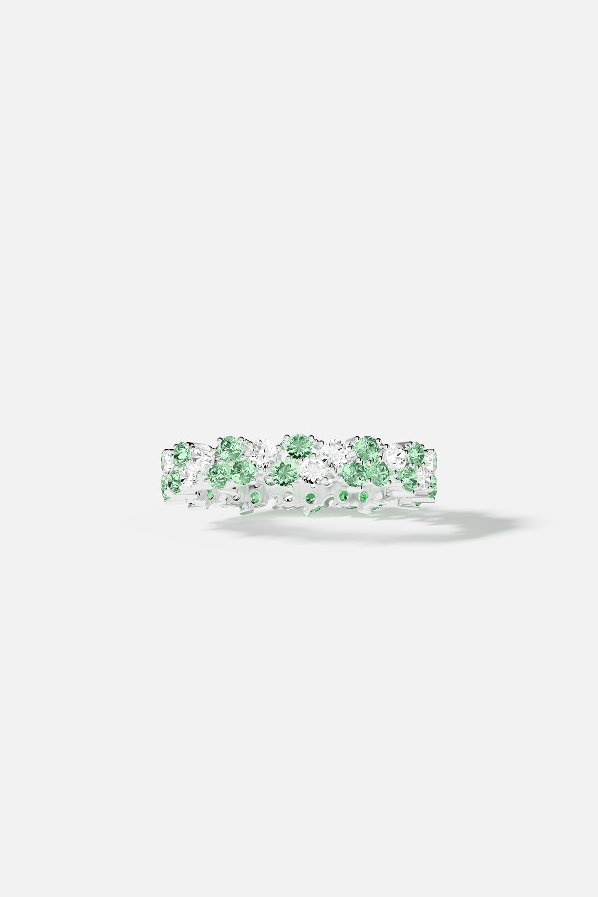Rings APM Monaco pastel green drop ring with alternating green and white stones set in a shiny metal band.