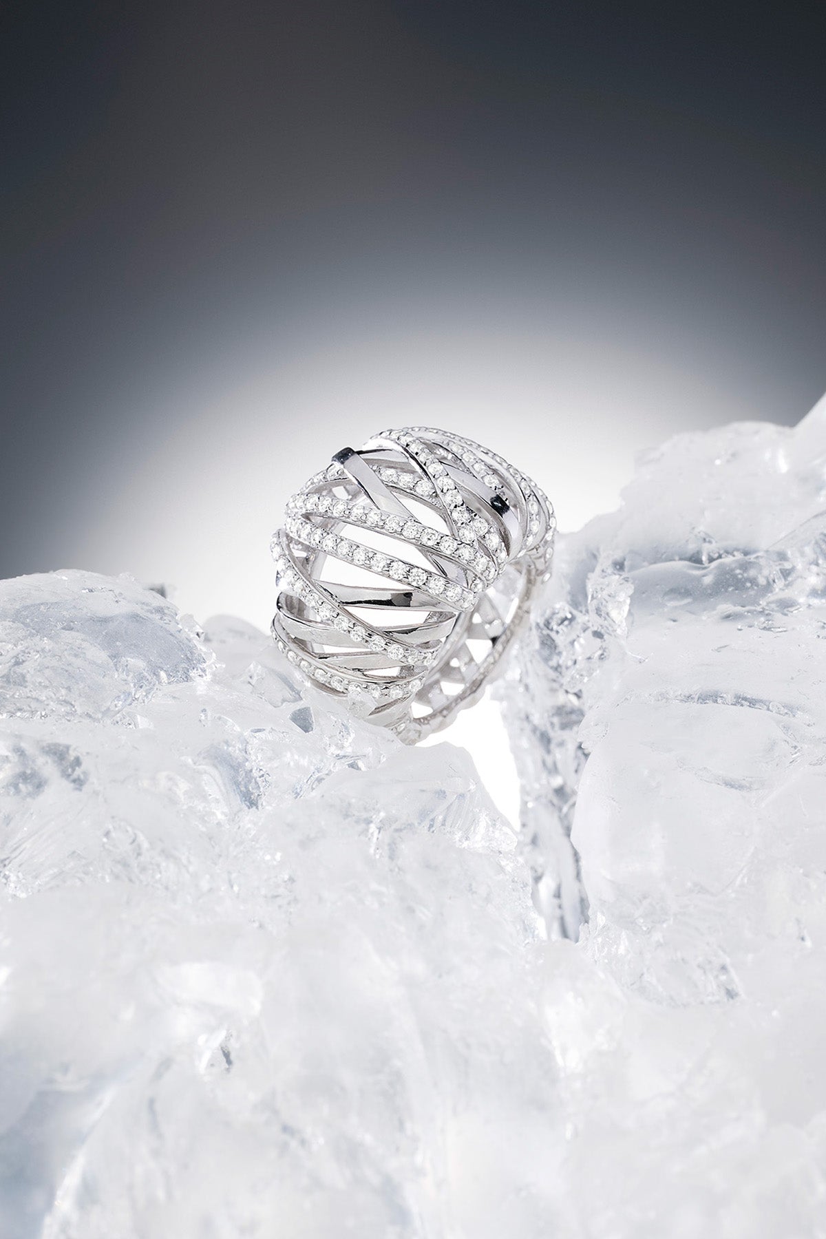 APM MONACO statement enlace ring in silver on a textured iced surface