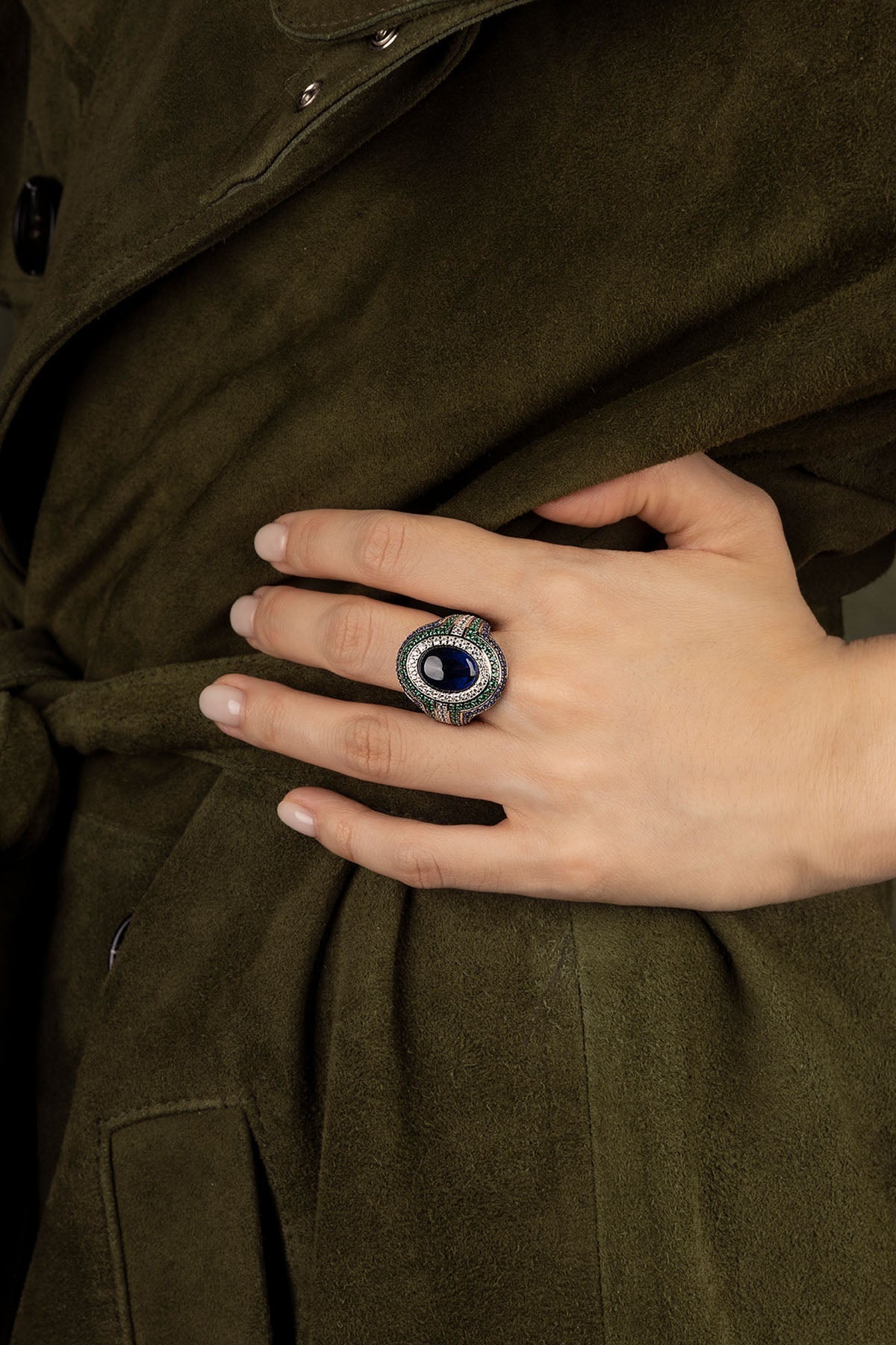 Hand wearing a APM Monaco Bold Green and Blue Ring in silver
