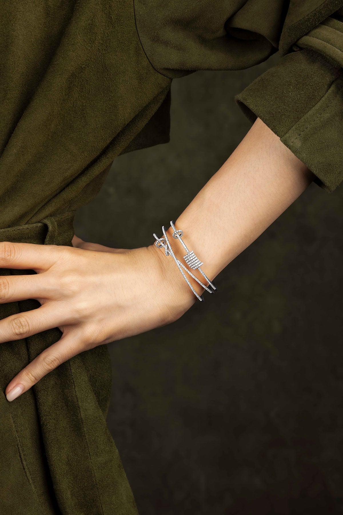Silver bracelet on a wrist with a dark background