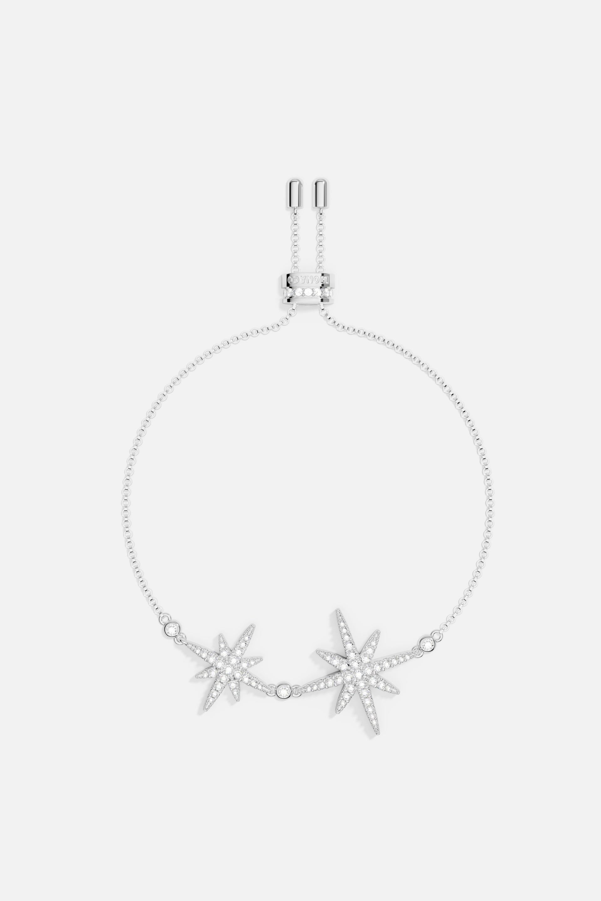 Bracelets APM Monaco: silver-tone charm bracelet with two jeweled starburst charms.