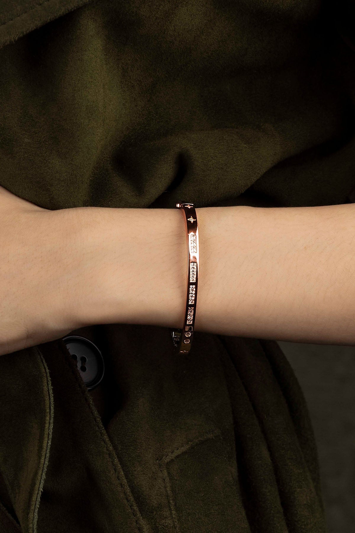 Bracelet on a wrist with a dark background