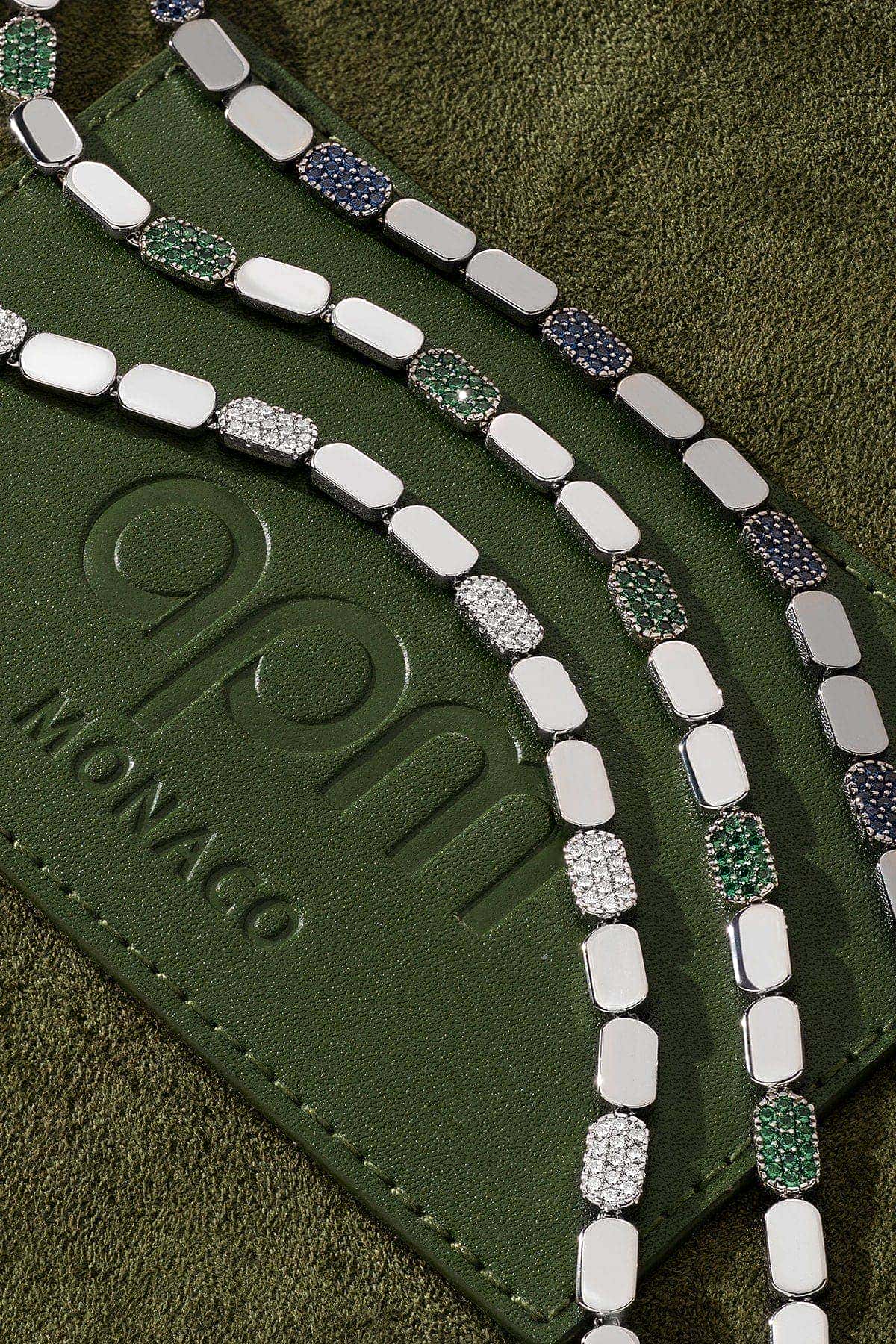 Silver bracelets display on the green background