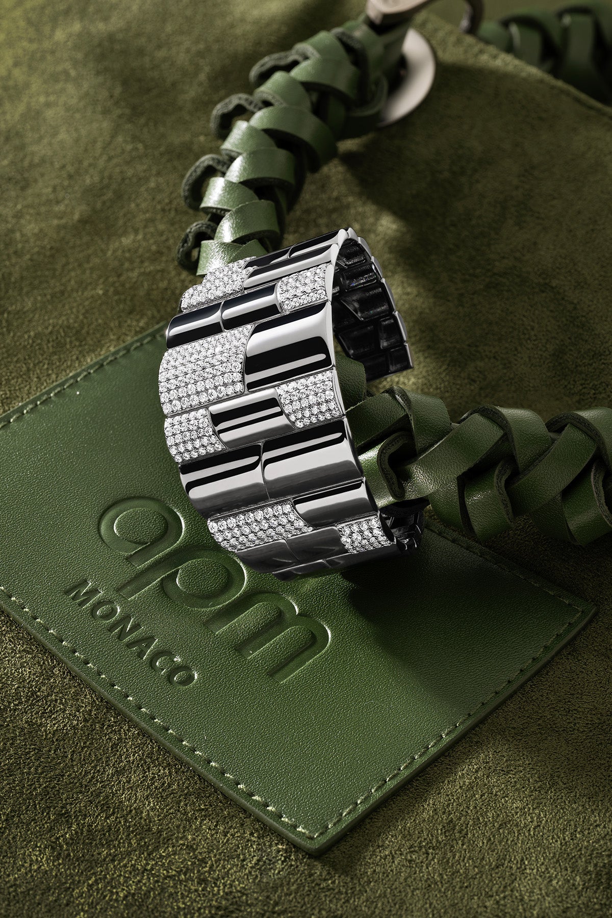 Statement Pavé Cuff on a green bag featuring a brand logo.