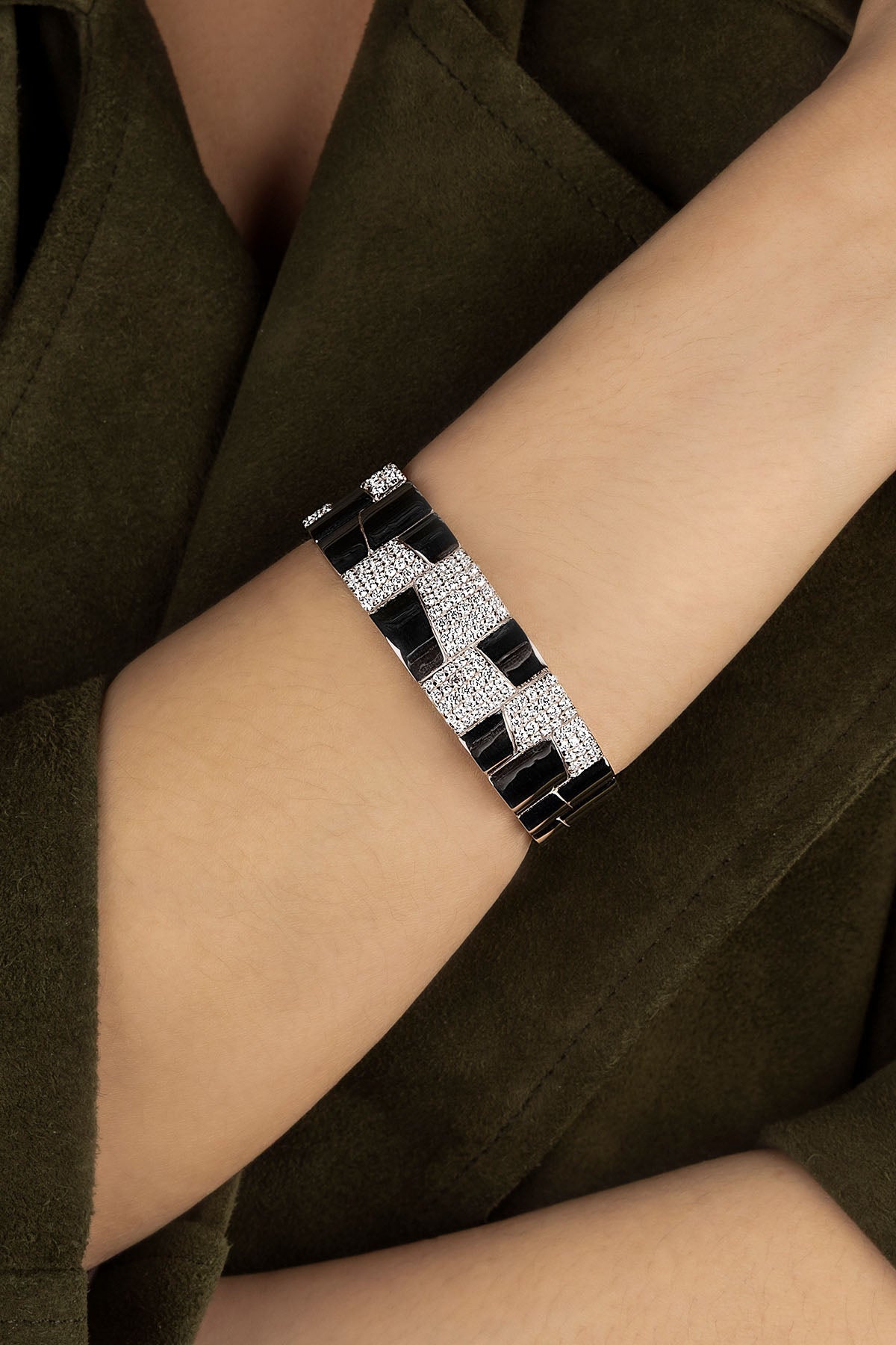 Close-up of a person wearing a cuff on a dark background