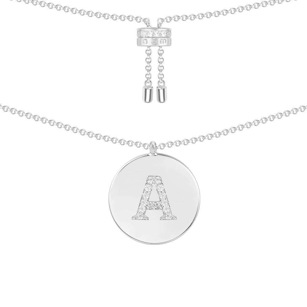 Necklaces APM Monaco. Silver-tone chain with a round pendant bearing a capital A made of diamonds.