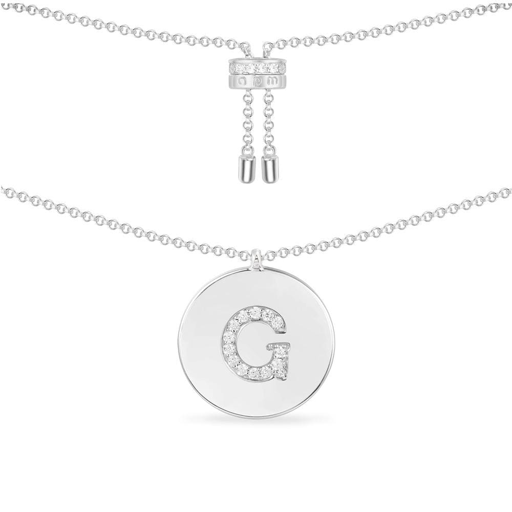 Necklaces APM Monaco, silver chain with a circular pendant featuring the letter G in pavé crystals.
