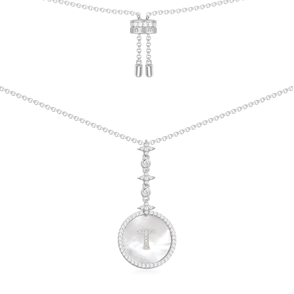 Necklaces APM Monaco: White gold necklace with a round pendant featuring a T at center, surrounded by pavé diamonds, on a slim adjustable chain.
