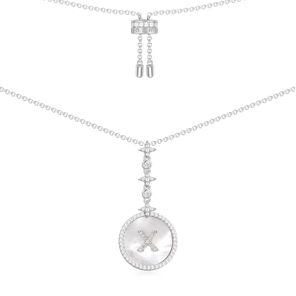 Necklaces APM Monaco: white gold necklace featuring a mother-of-pearl pendant inscribed with the letter X, bordered by a halo of diamonds.