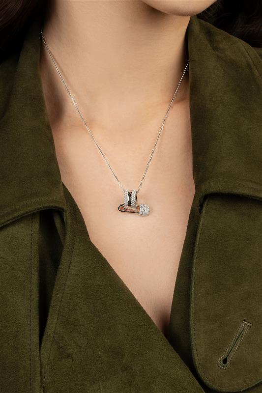 Necklace with a pendant worn by a person wearing a green jacket.