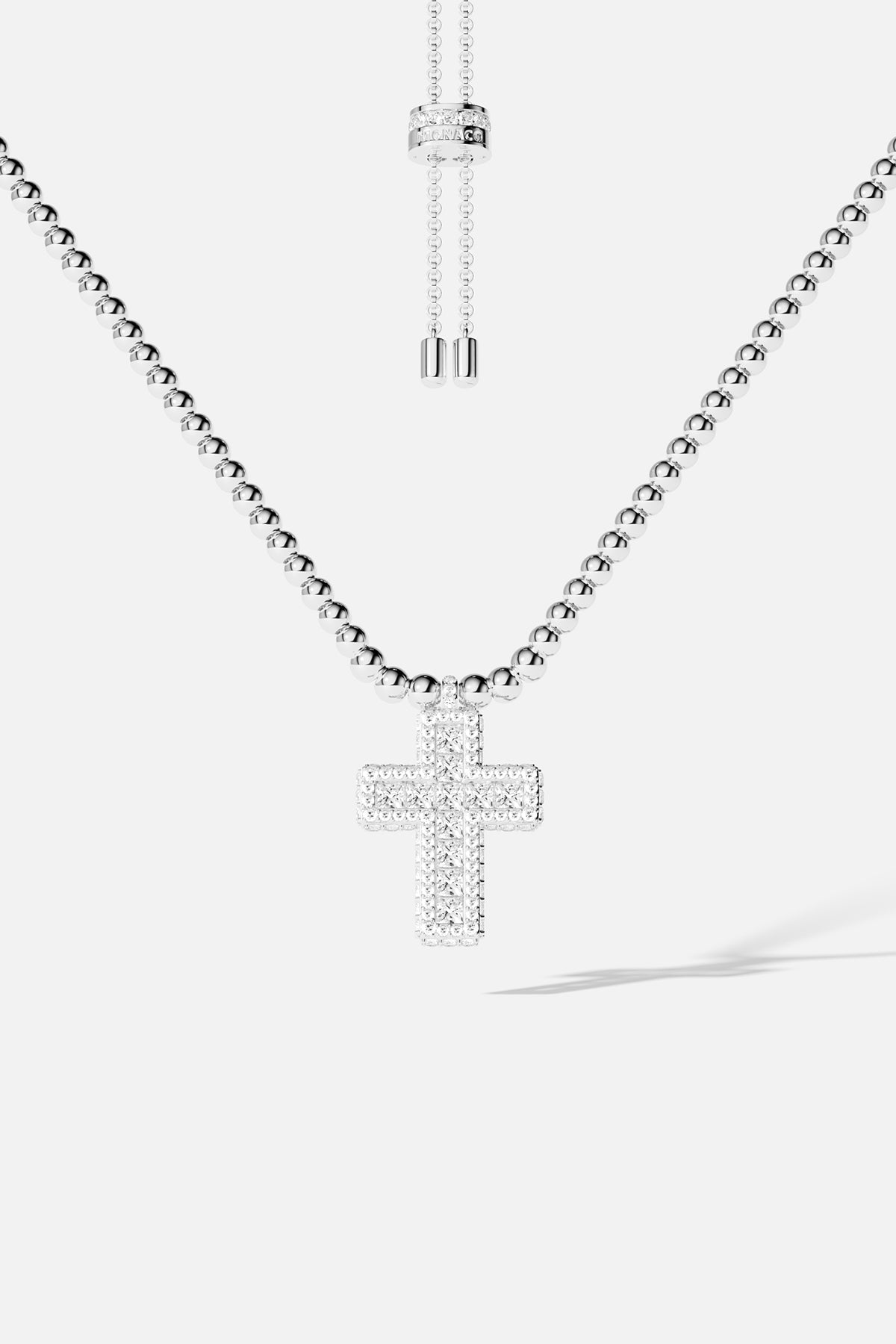 Necklaces APM Monaco with a beaded, adjustable chain and a pavé cross pendant.