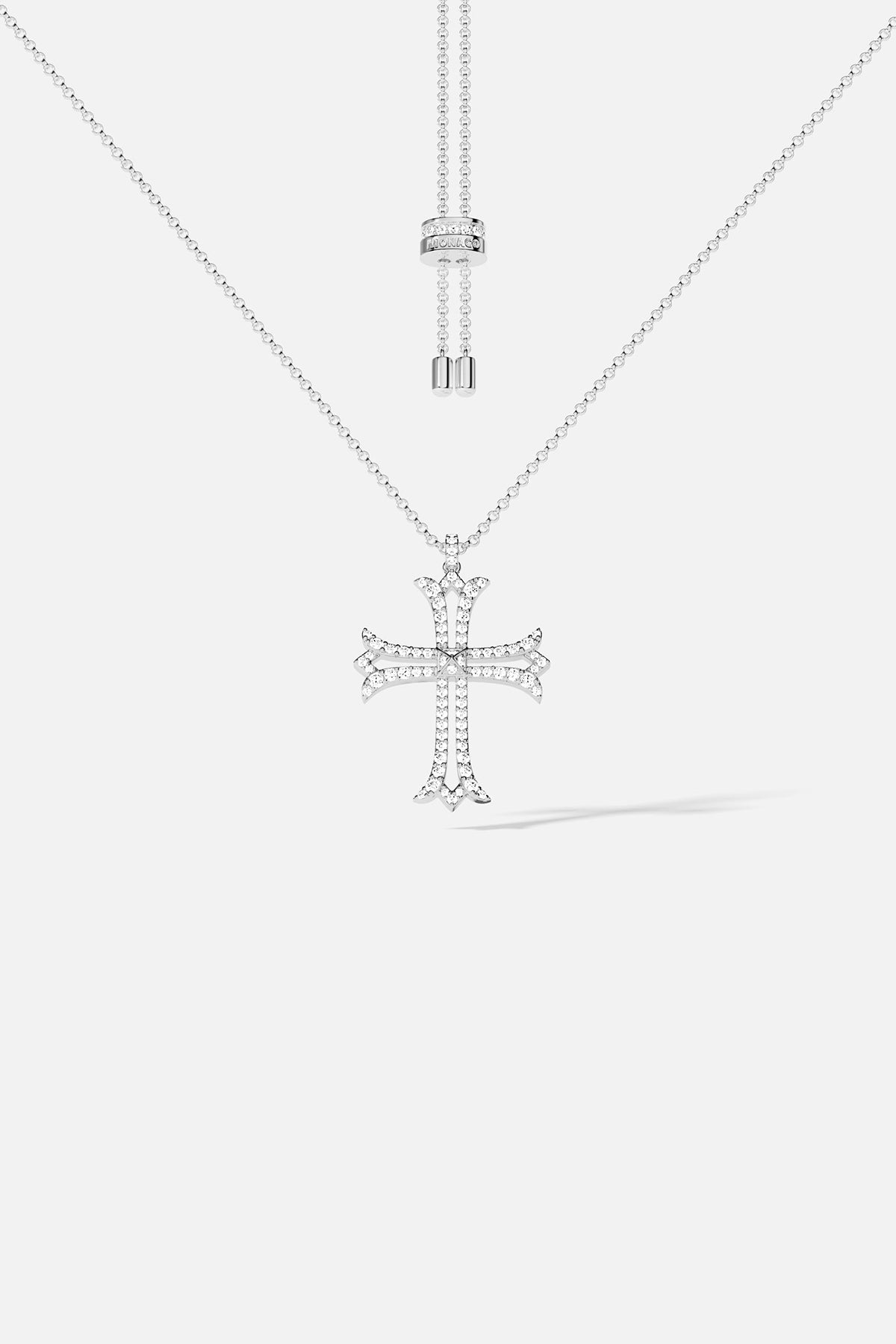 Silver cross pendant necklace on a white background