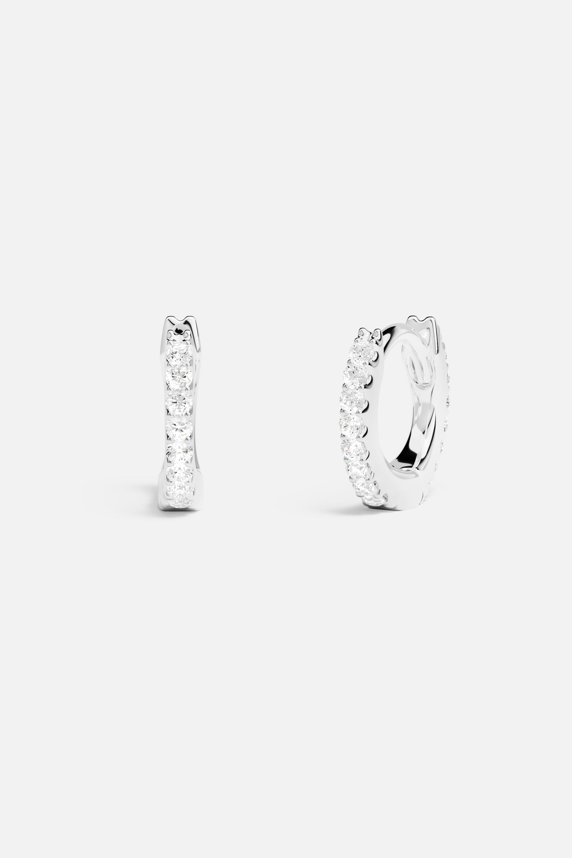 Earrings APM Monaco silver-tone small 6-mm pavé hoop earrings with white stones.