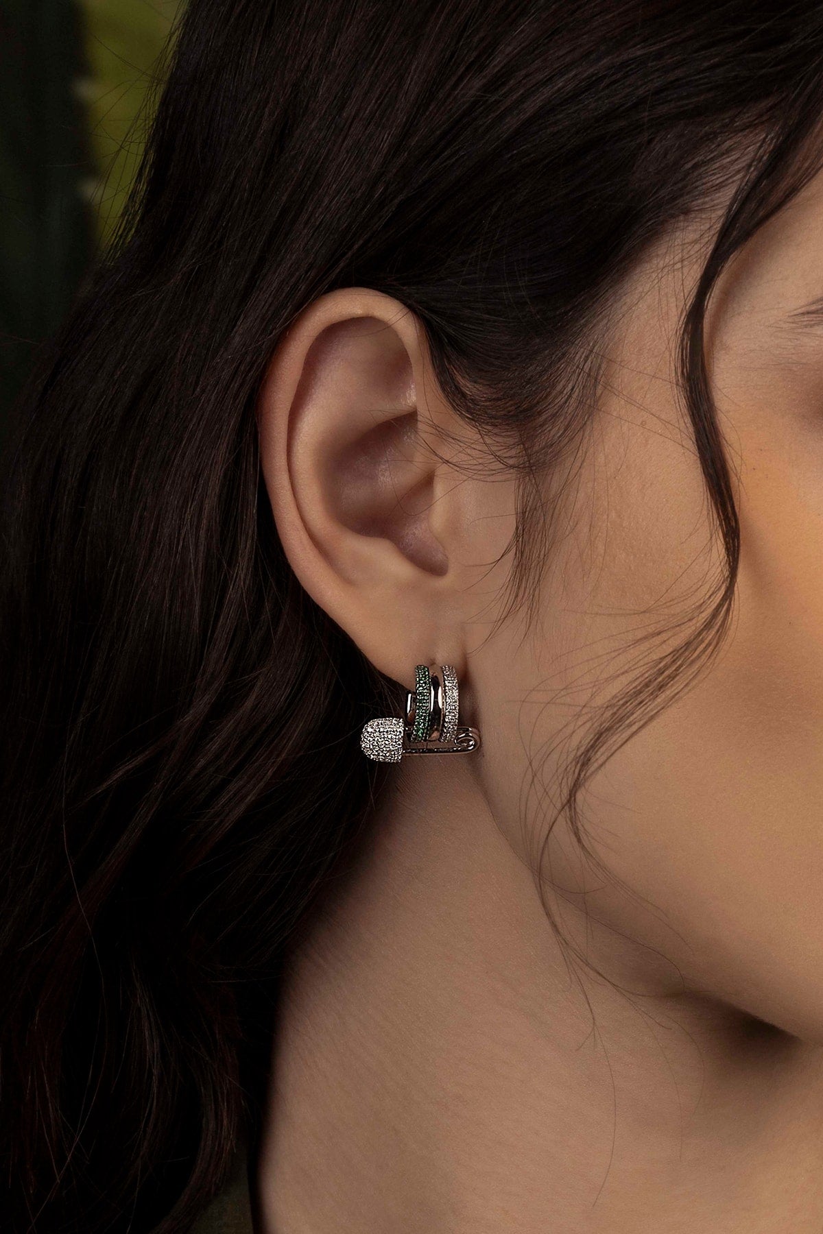 Close-up of an earring worn by a model
