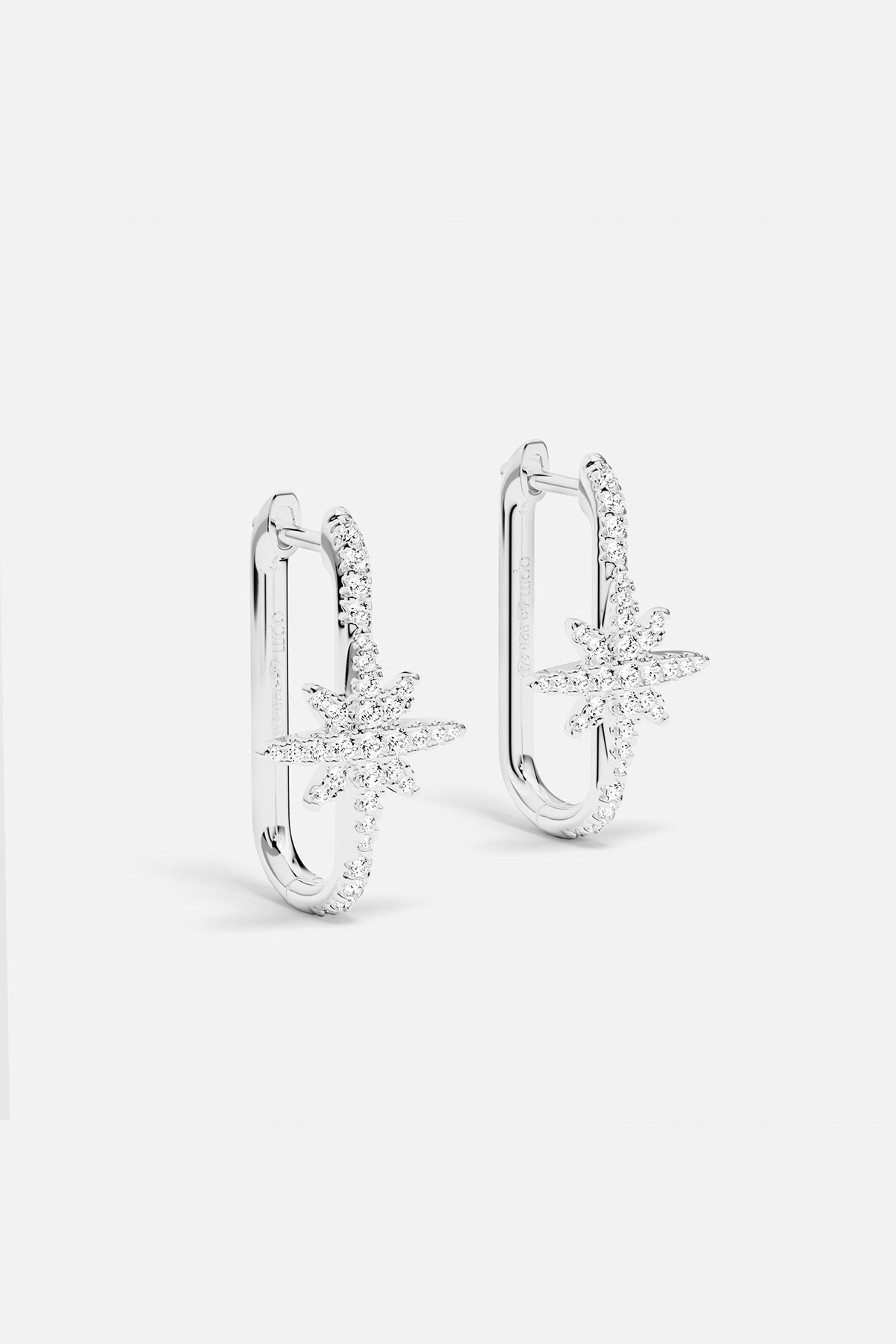 Earrings APM Monaco, silver-tone pair featuring a star-shaped and a U-shaped design.