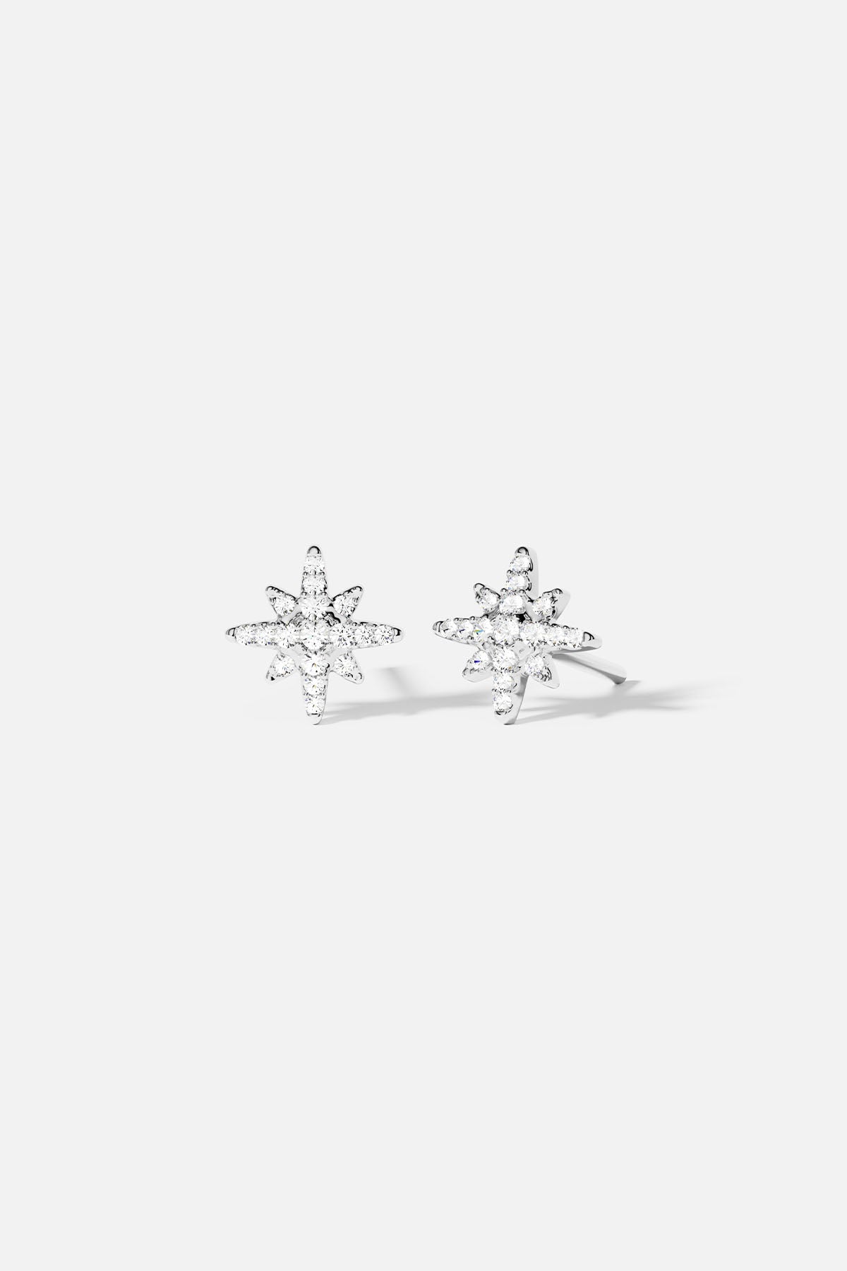 Earrings APM Monaco. silver star-shaped stud earrings with meteorite texture.