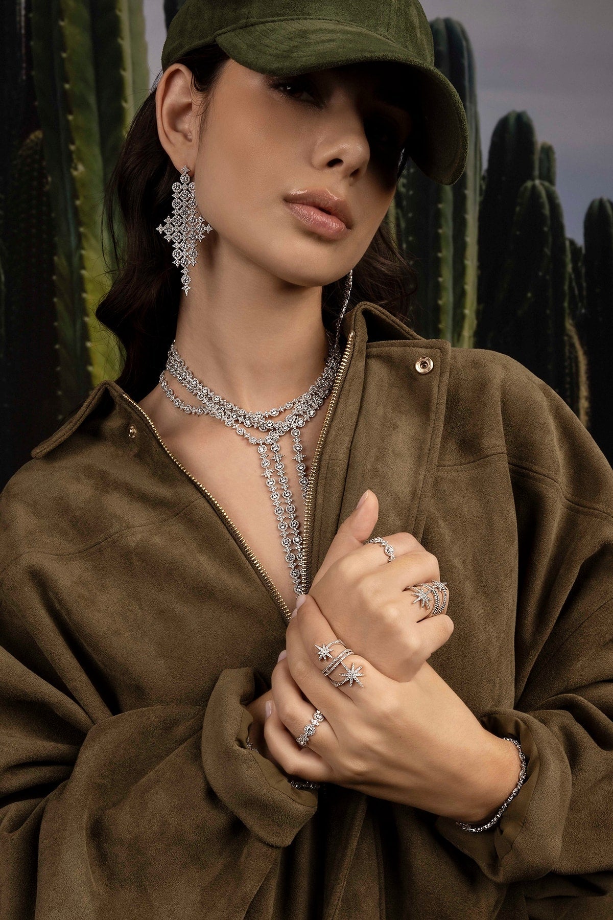 Woman wearing jewelry with cacti in the background