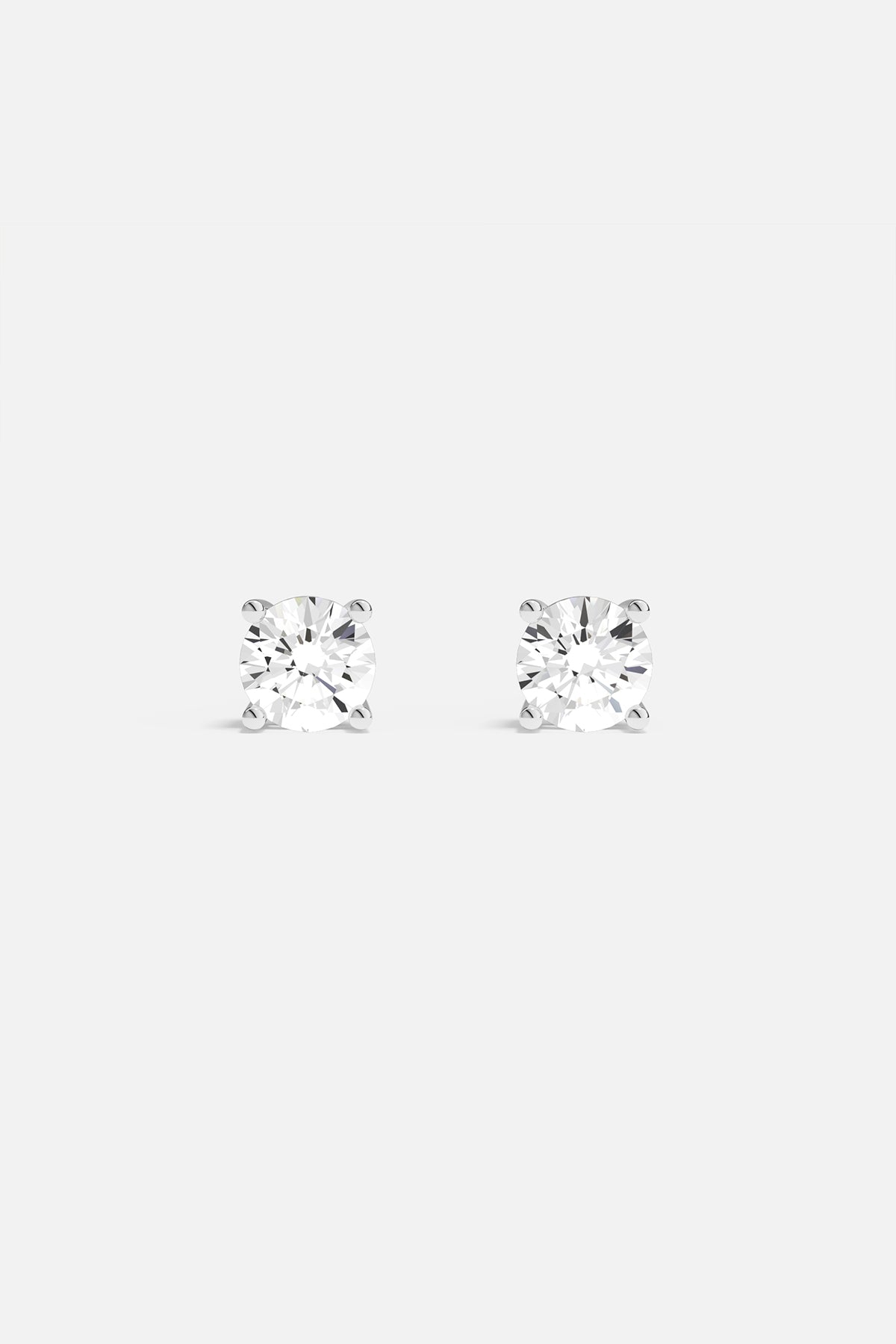 Earrings APM Monaco round stud earrings with clear white diamonds.