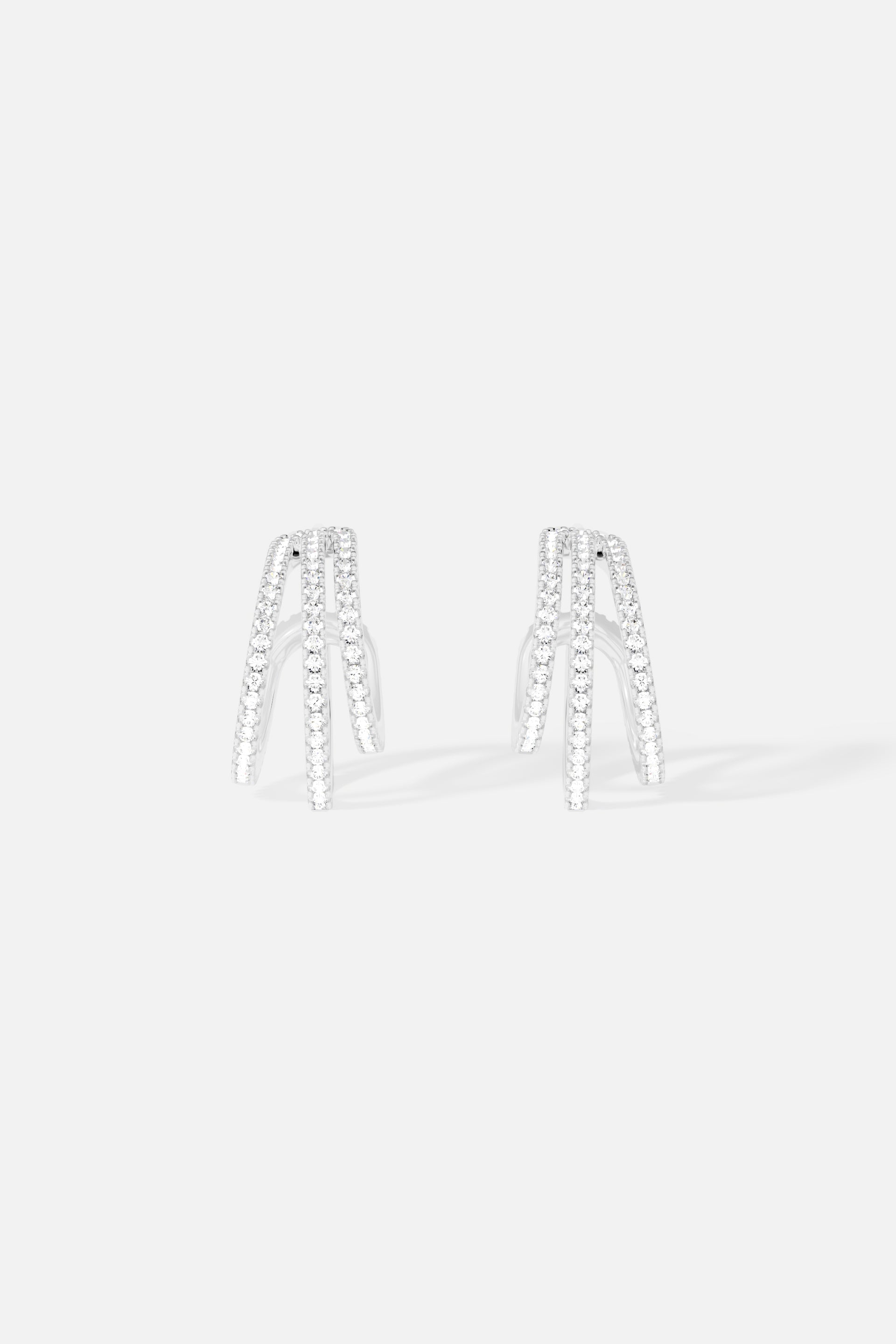 Earrings APM Monaco triple hoop design in white metal with pavé crystals.