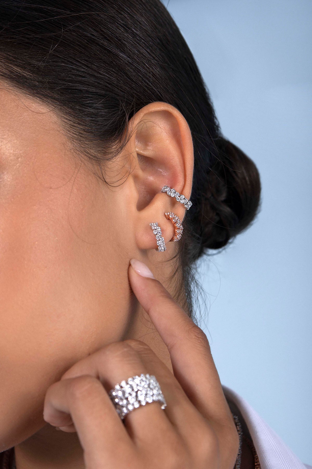 Earrings APM Monaco – pavé huggie hoops in white with diamonds.