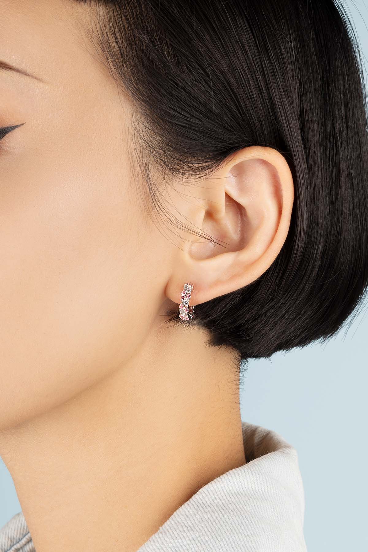 Earrings APM Monaco rose drop on a rose-gold huggie, minimalist design.