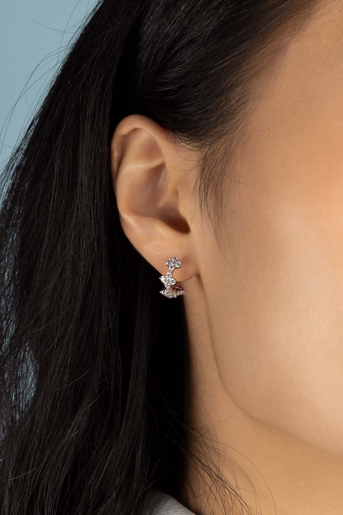 Earrings APM Monaco, spark-huggie floral hoops with pavé crystals.