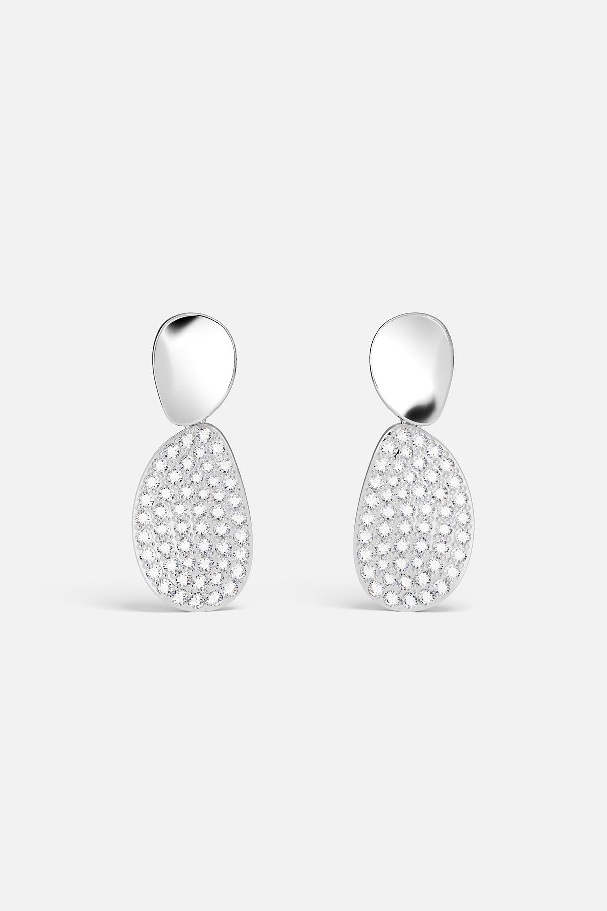 Earrings APM Monaco, two drop earrings with a glossy white-silver freeform top connected to a larger pavé-diamond teardrop.