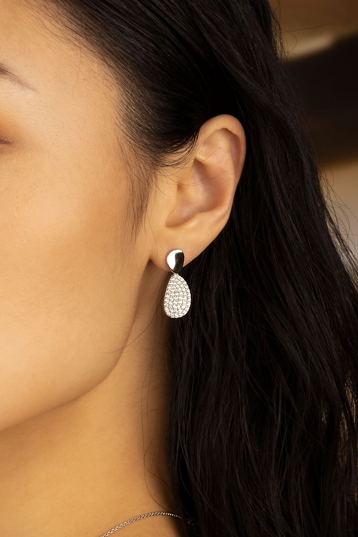 Earrings APM Monaco — white-silver drop earring with pavé diamonds.