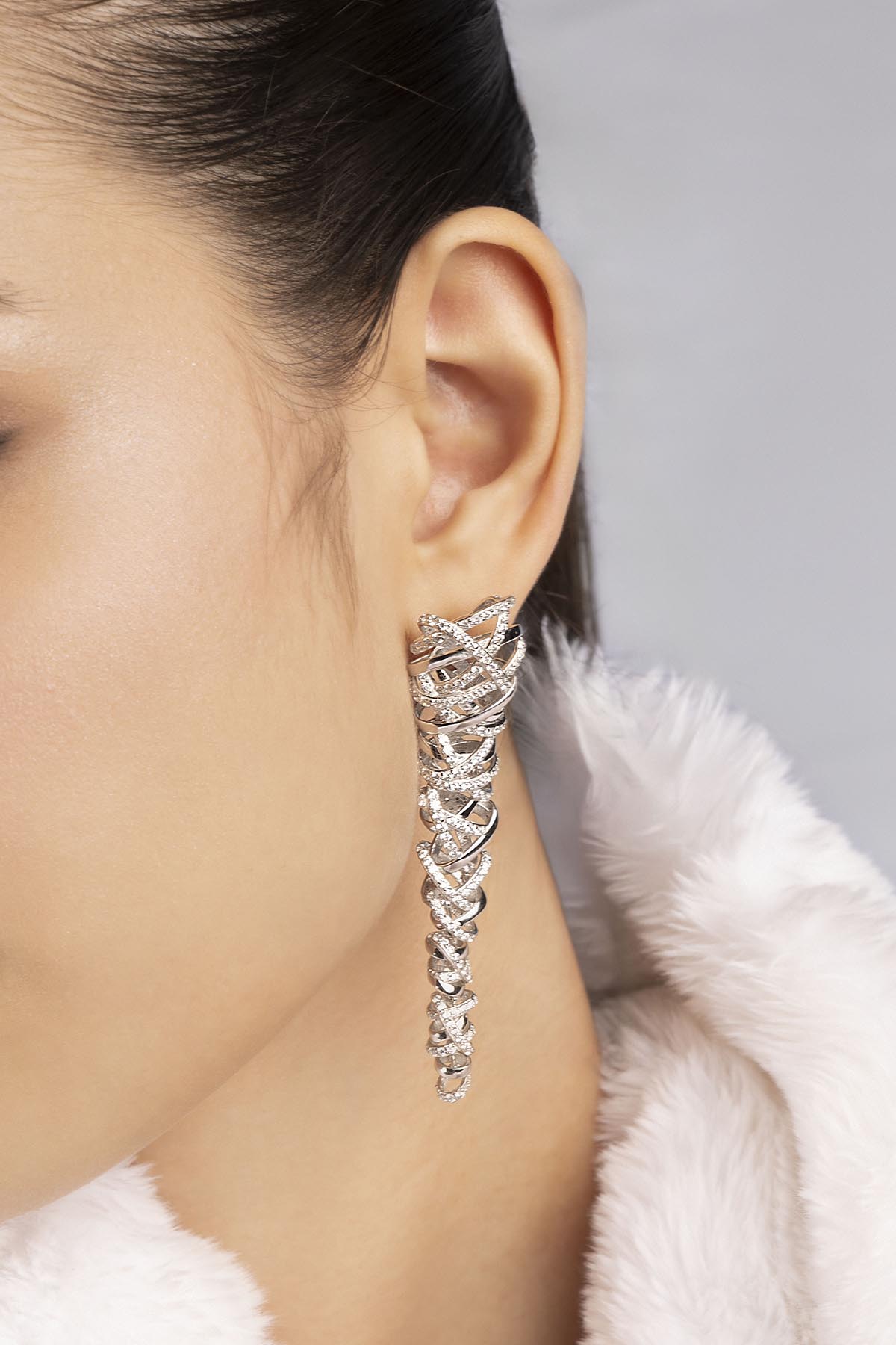 one of APM MONACO enlace earring in silver worn on model