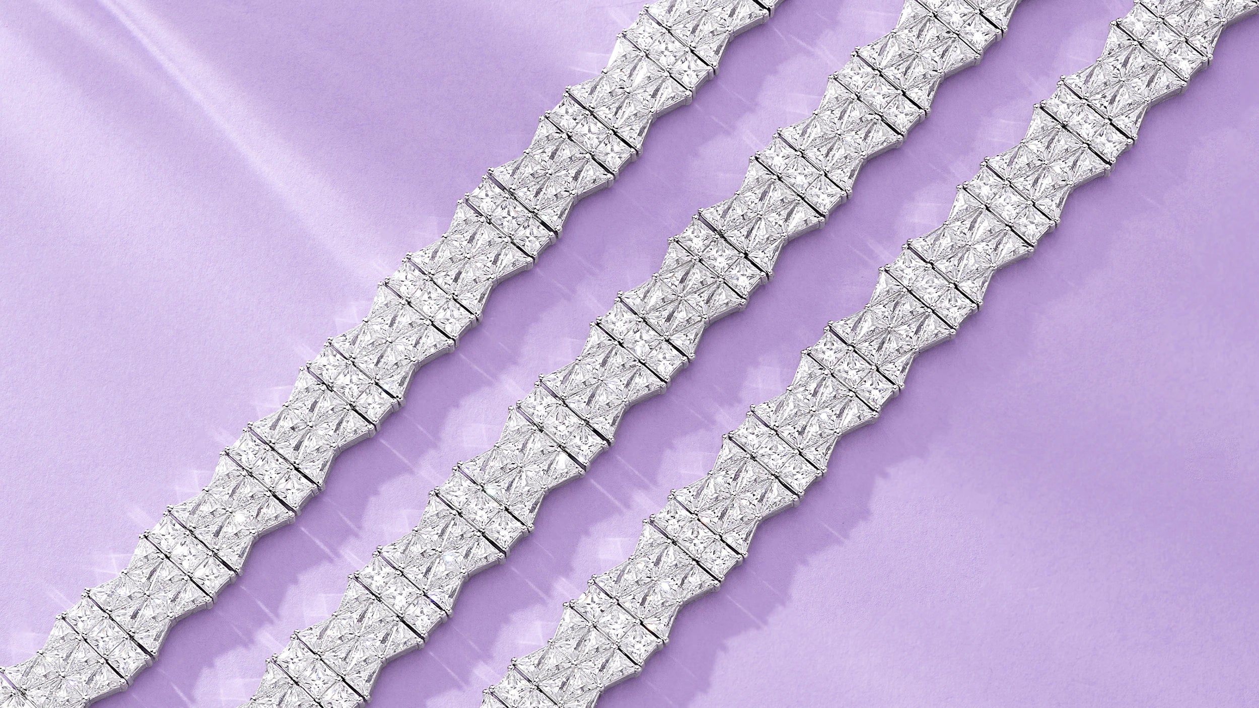 APM MONACO silver torsade bracelets on a light purple background