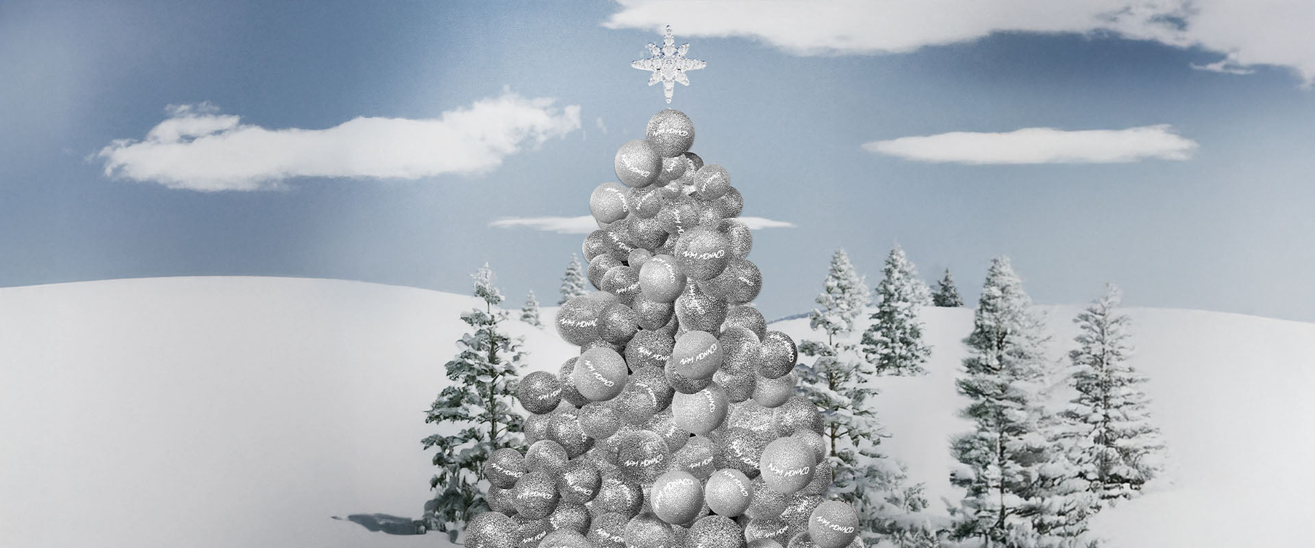 Decorative Christmas tree made of silver APM MONACO ornaments against a snowy landscape with trees.