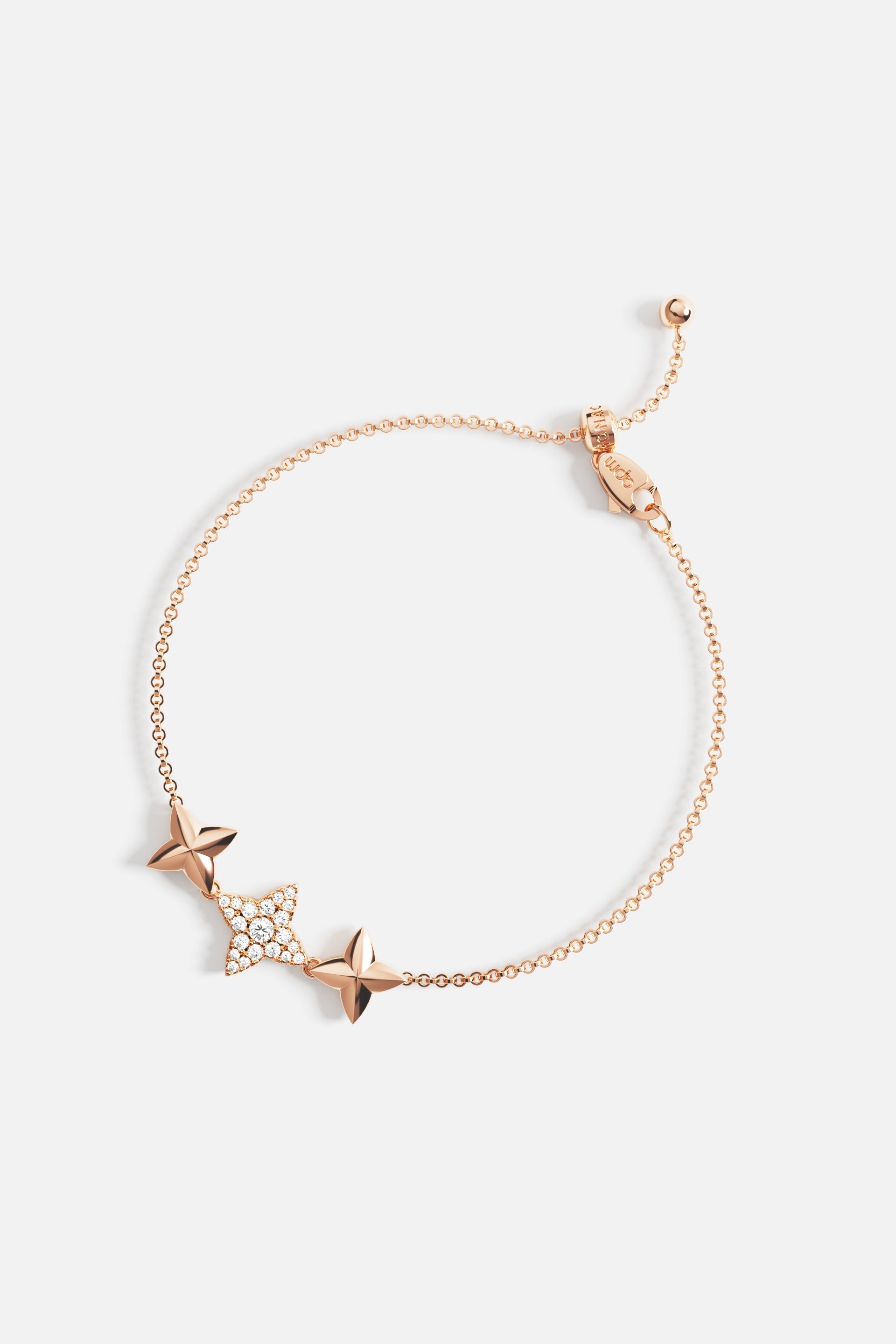 Bracelets APM Monaco: rose-gold-tone chain bracelet with decorative four-pointed star charms, one encrusted with sparkling gems; adjustable.