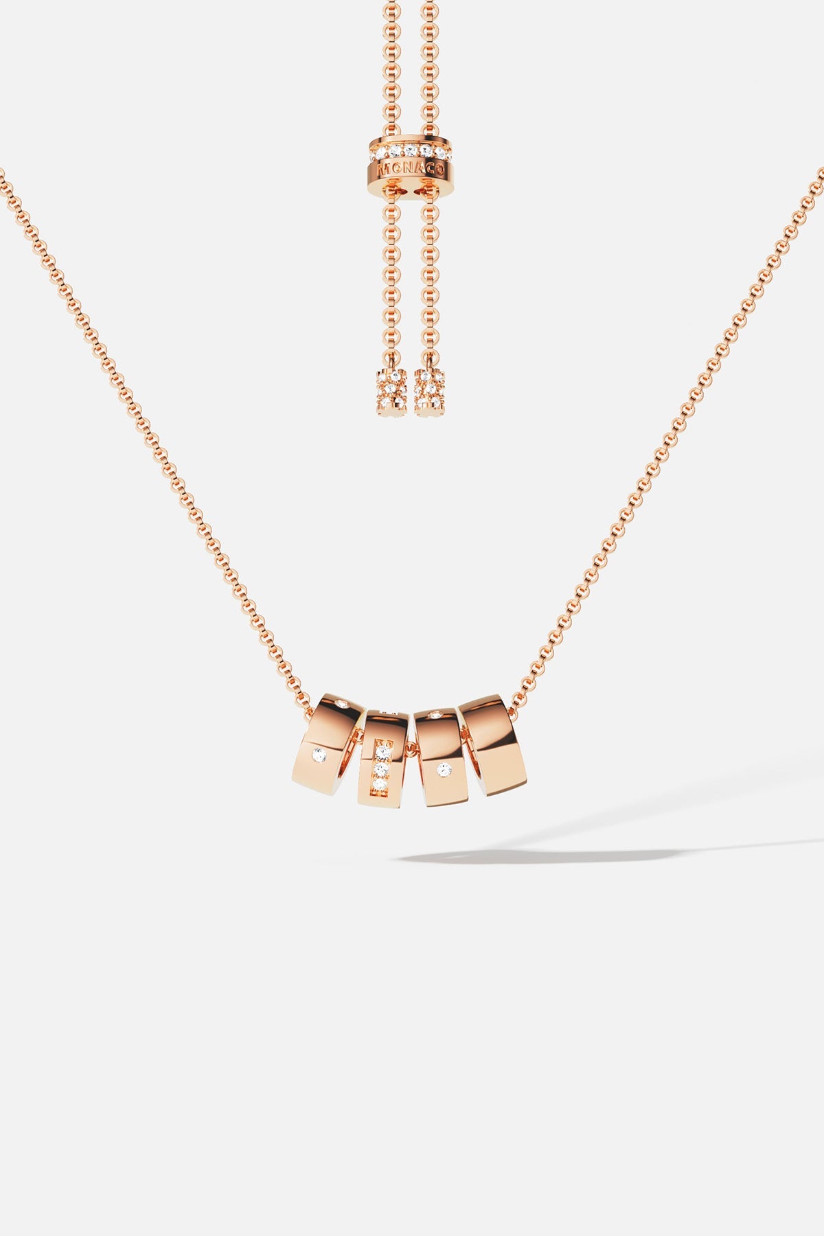 Necklaces APM Monaco: Rose gold adjustable necklace with square charms, some encrusted with crystals, suspended from a delicate chain.