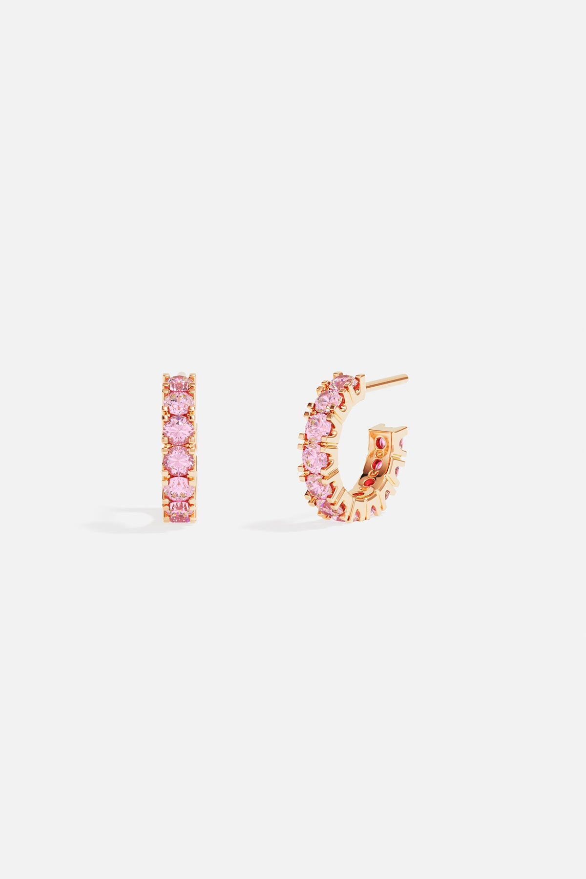 Earrings, APM Monaco: yellow gold pavé huggie hoops encrusted with pink gemstones.