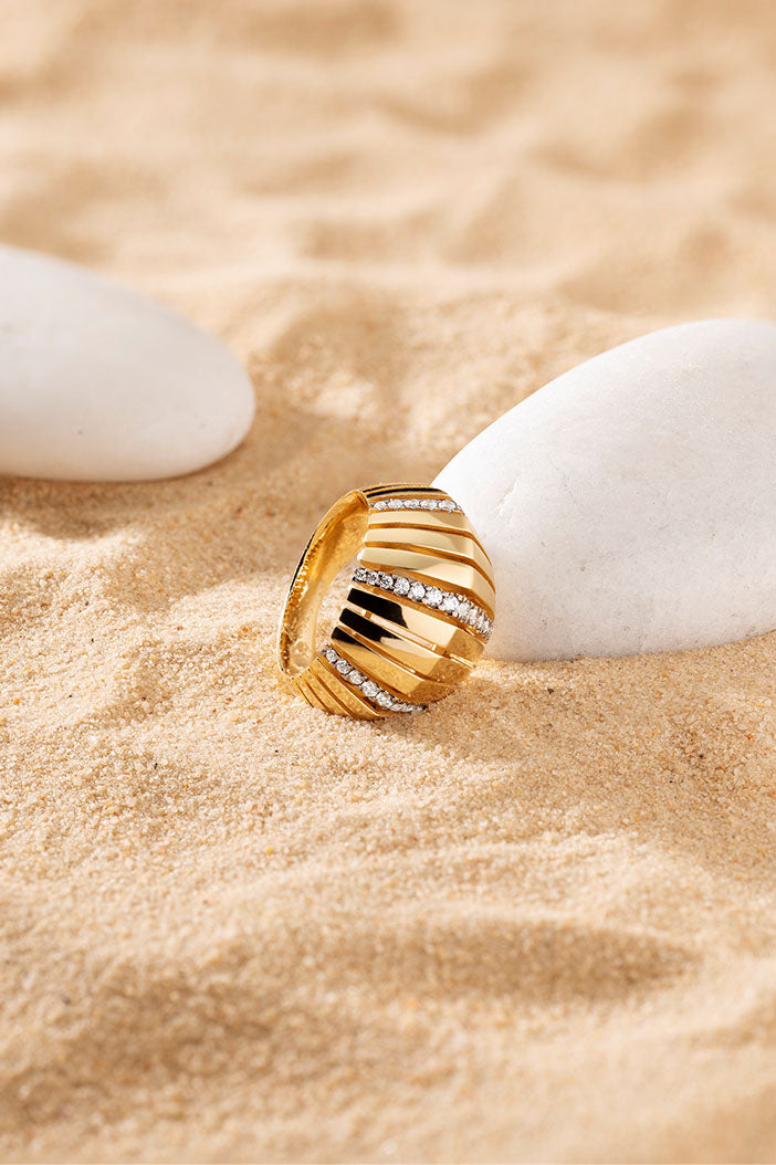 Rings APM Monaco yellow gold sunray pavé ring with small white stones.