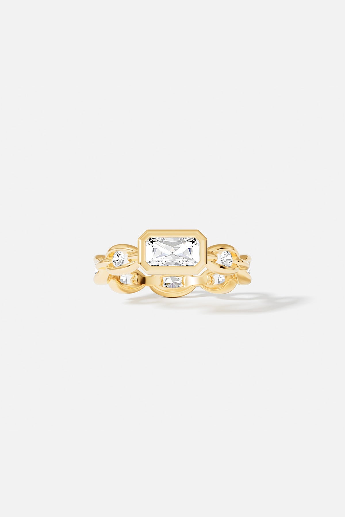 Rings APM Monaco yellow gold chain ring featuring a large rectangular clear stone.