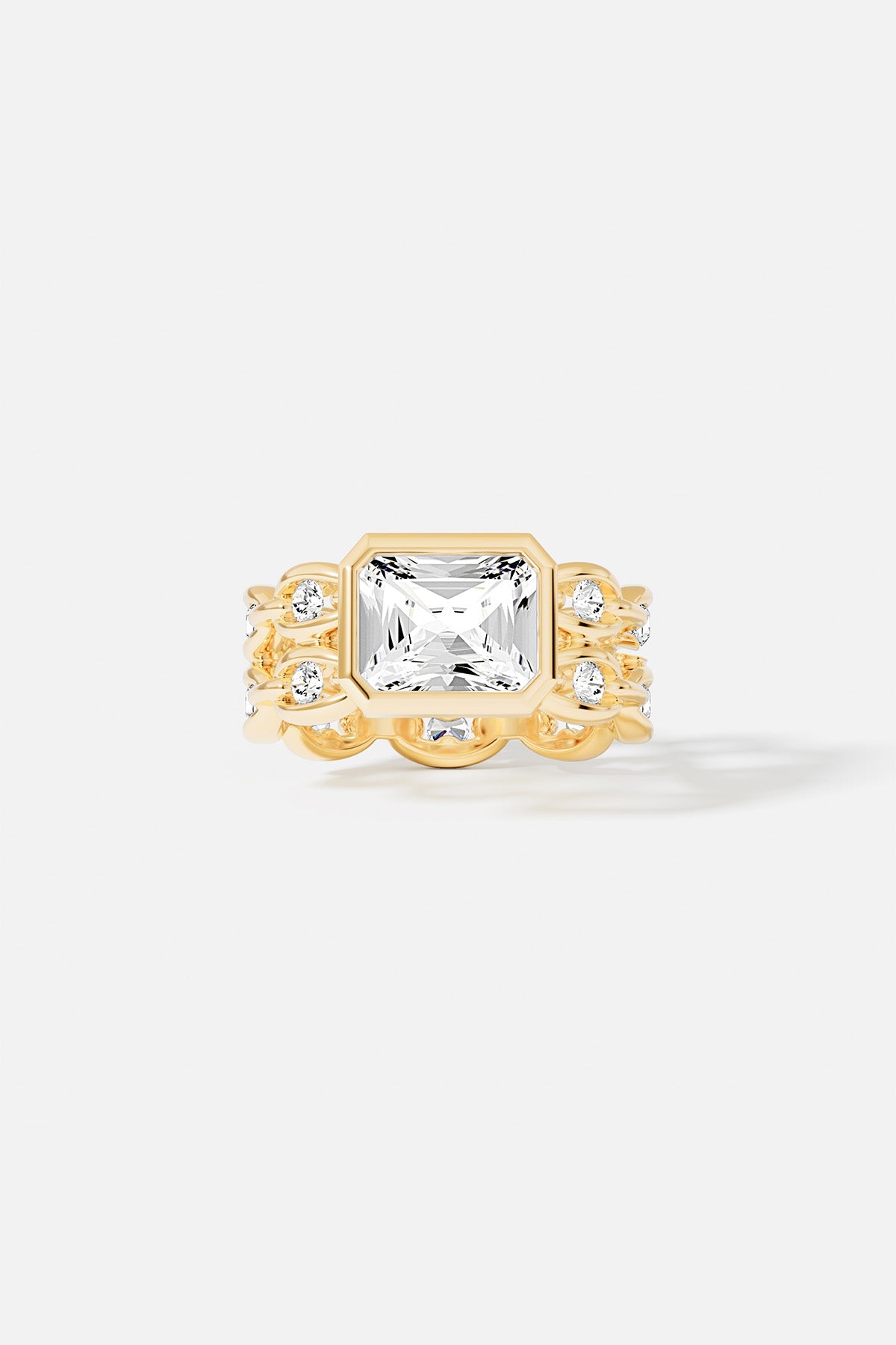 Rings APM Monaco yellow gold statement ring with a large square-cut white center stone surrounded by a pavé halo of smaller stones.