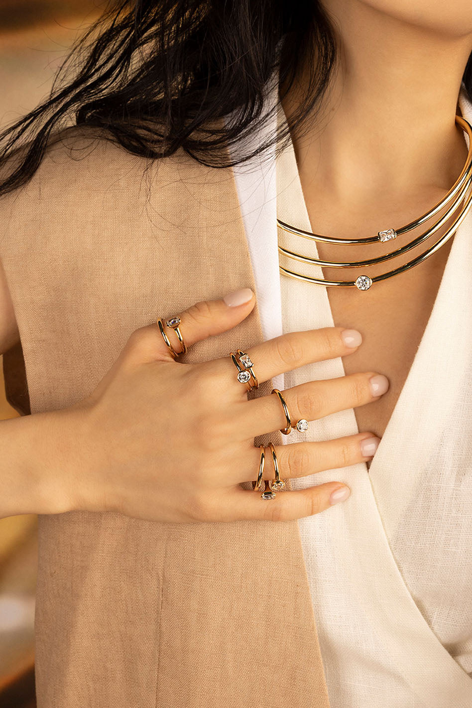 Rings APM Monaco: yellow gold gemstone rings on a hand with matching choker necklaces.