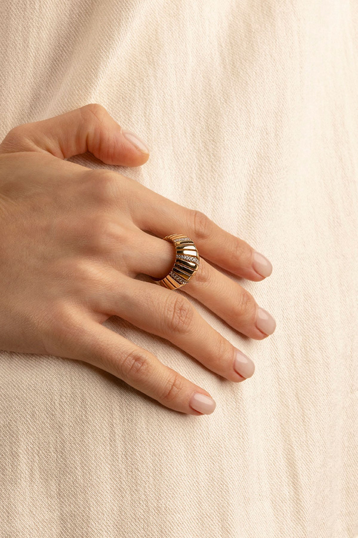 Rings APM Monaco. Yellow gold-tone sunray motif ring worn on the finger, with delicate radiating design.