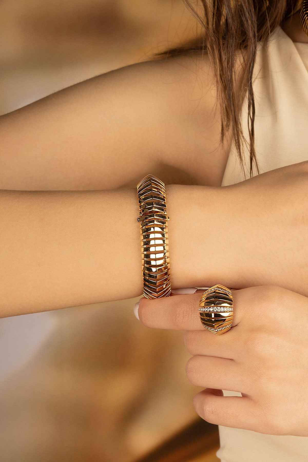 Bracelets APM Monaco in yellow gold with sunray geometric detailing.