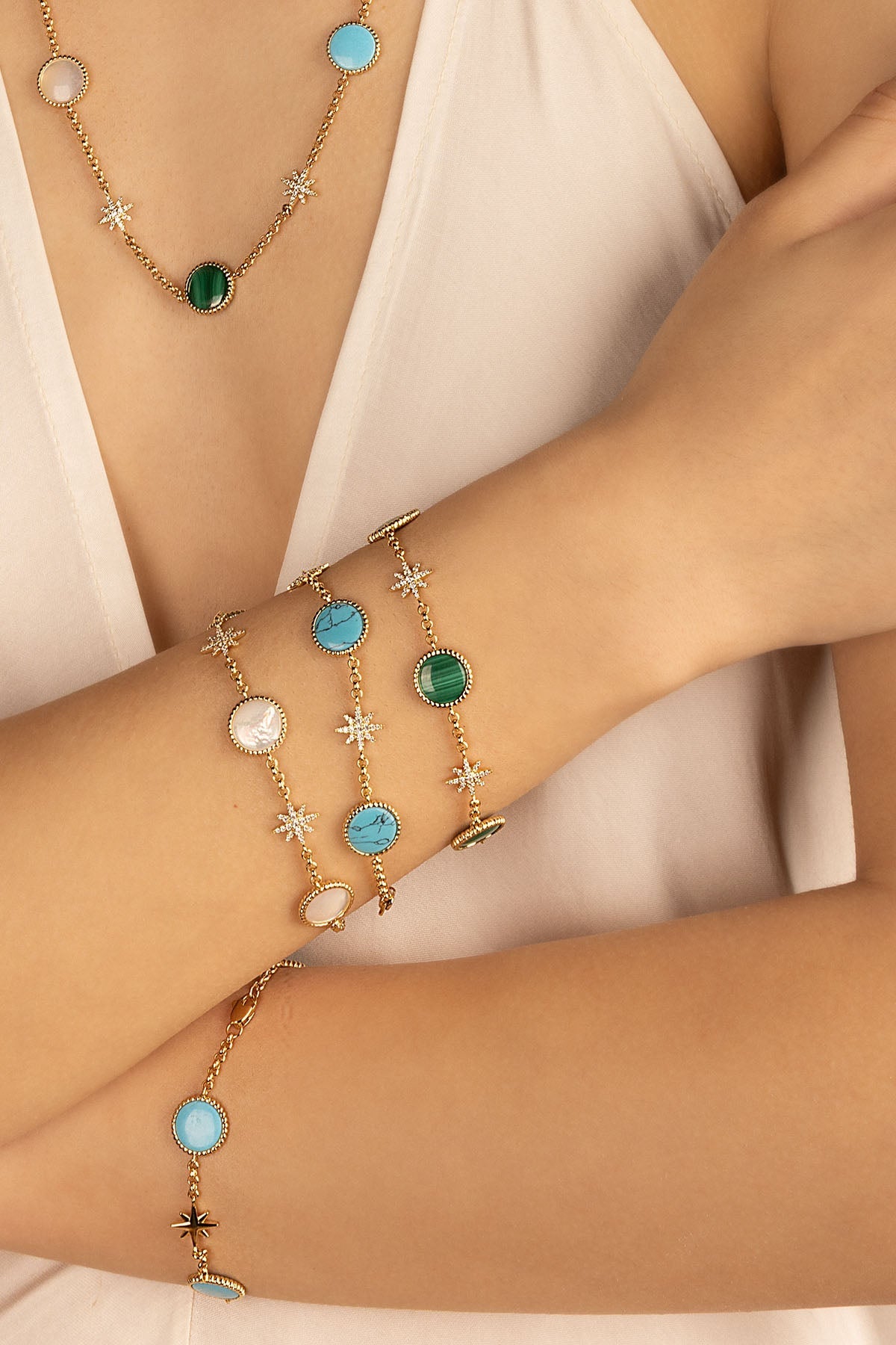 Bracelets APM Monaco in yellow gold with malachite green stones and blue-white accents, multistrand design.