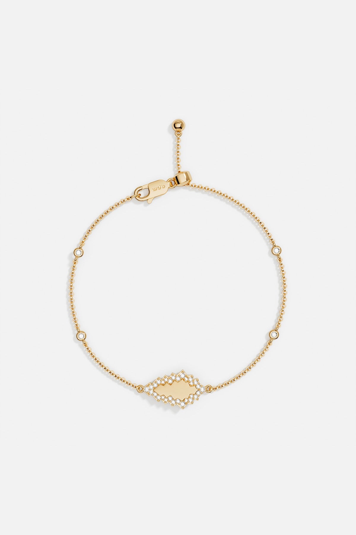 Bracelets APM Monaco: yellow gold adjustable chain bracelet with a shaped charm and clear stones, lobster claw clasp.