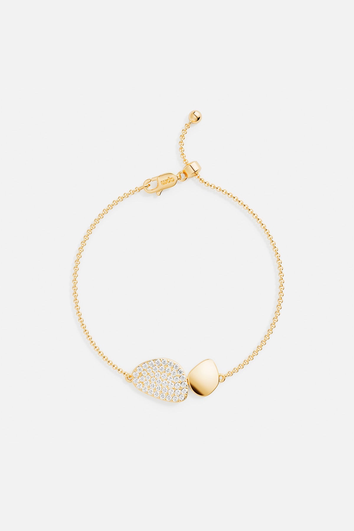 Bracelets APM Monaco, yellow gold adjustable galet bracelet with a pebble-shaped pavé detail.